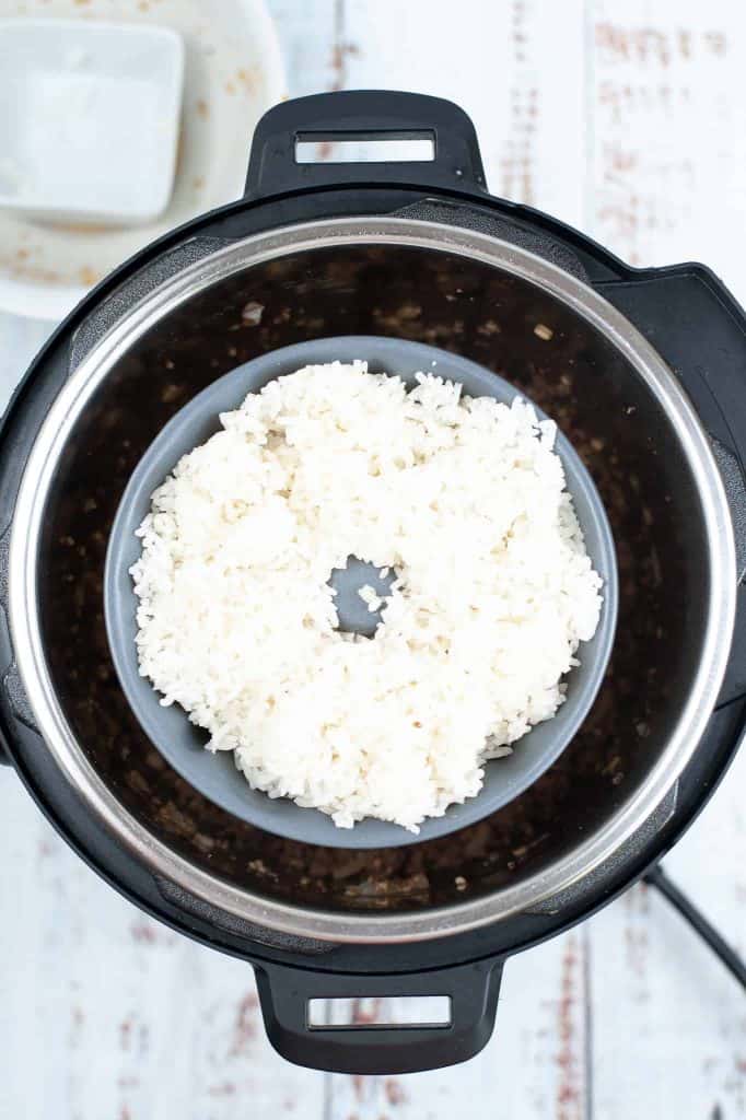White rice in pan on top of trivet in instant pot.