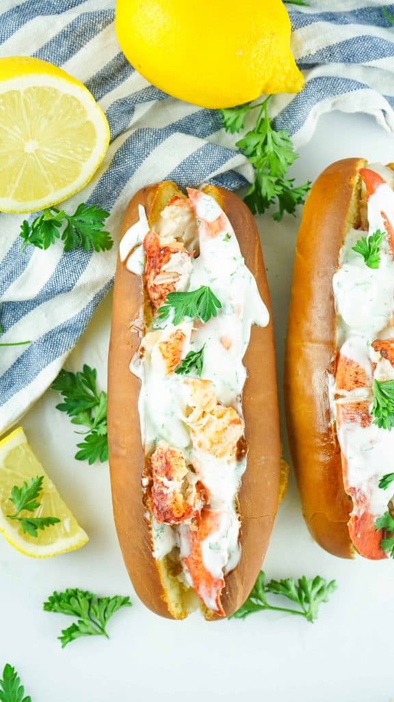 Overhead view of 2 lobster rolls side by side.