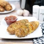 Spiralized baked potatoes on a white plate.