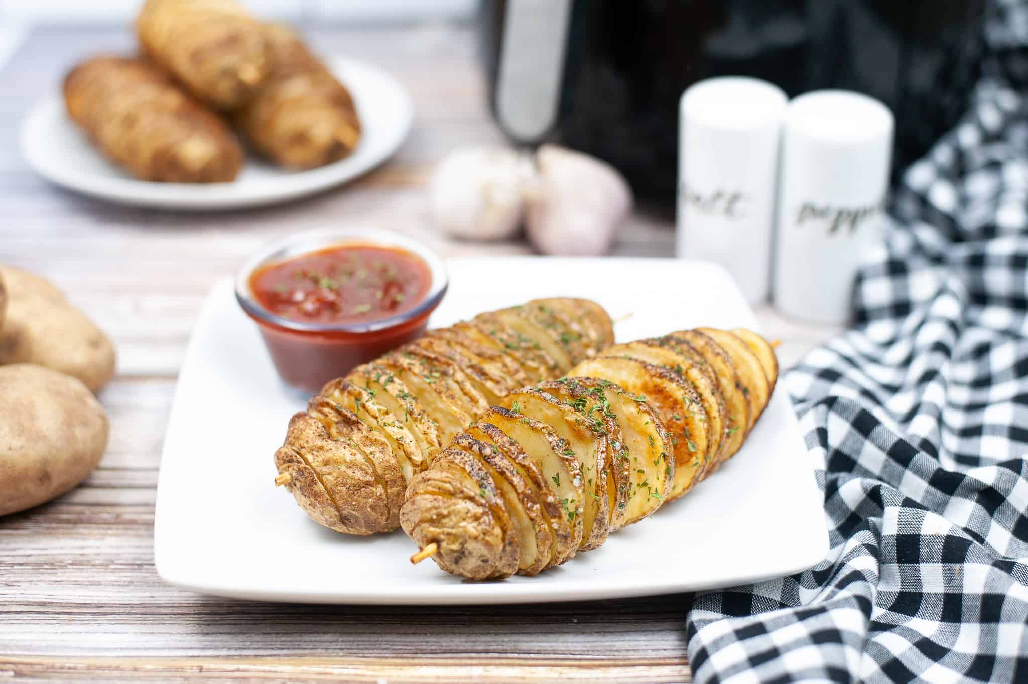 Spiralized baked potatoes on a white plate.