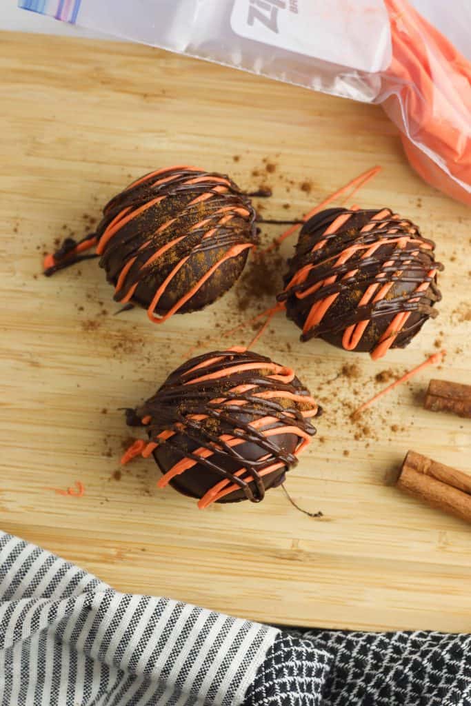 Decorating pumpkin spice latte bombs.