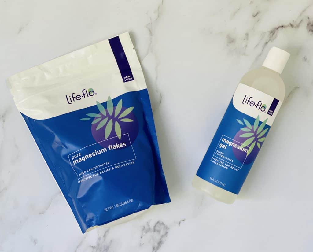 Life-flo products for self-care on a marble background.