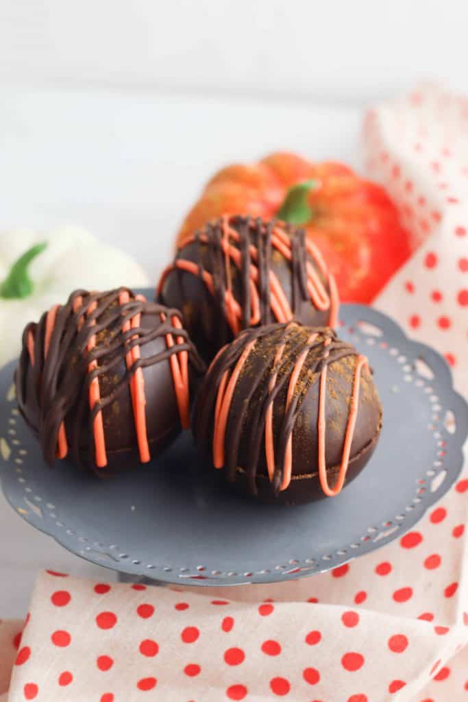 Pumpkin Spice latte bombs on a grey plate.