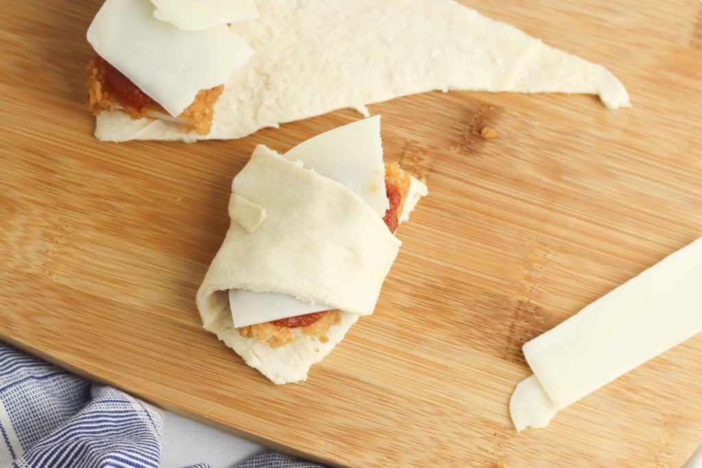 Chicken strip wrapped with crescent roll dough.
