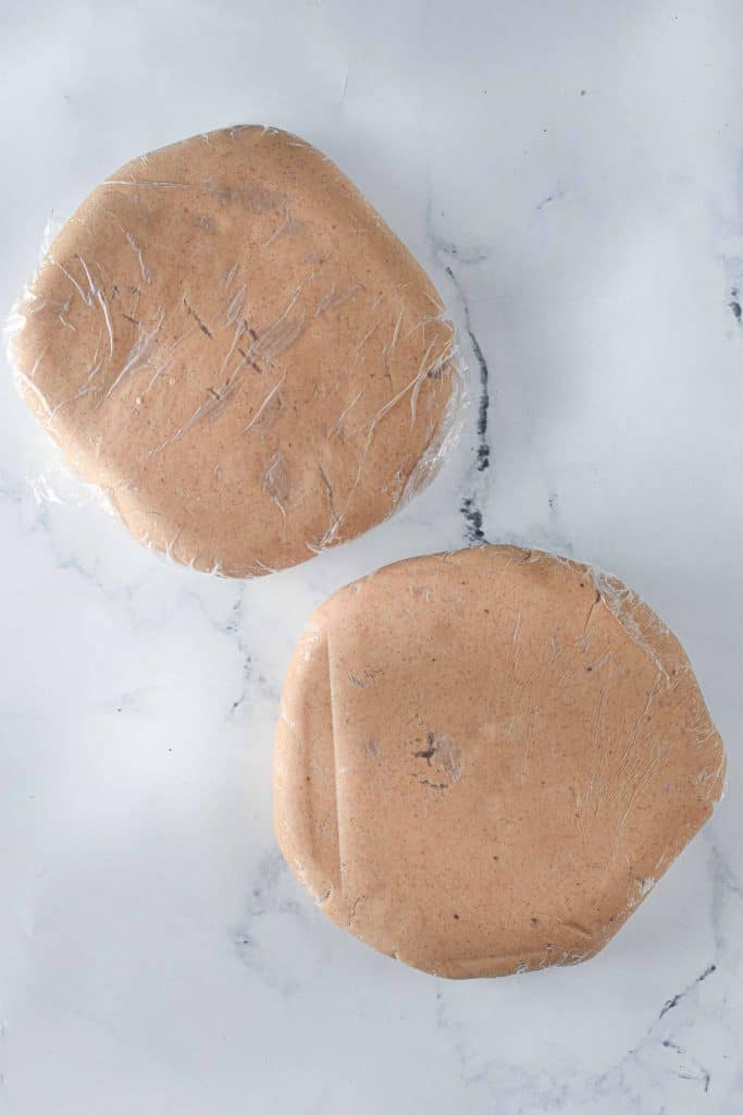 Gingerbread cookie dough divided in half and chilling