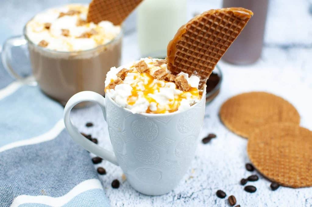 Latte with whipped cream and caramel drizzle.