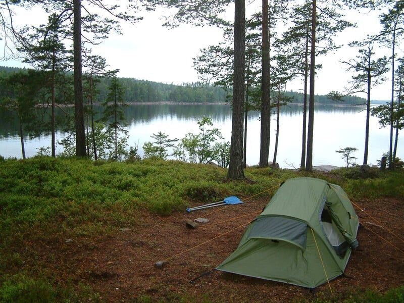 Tent beside lake.
