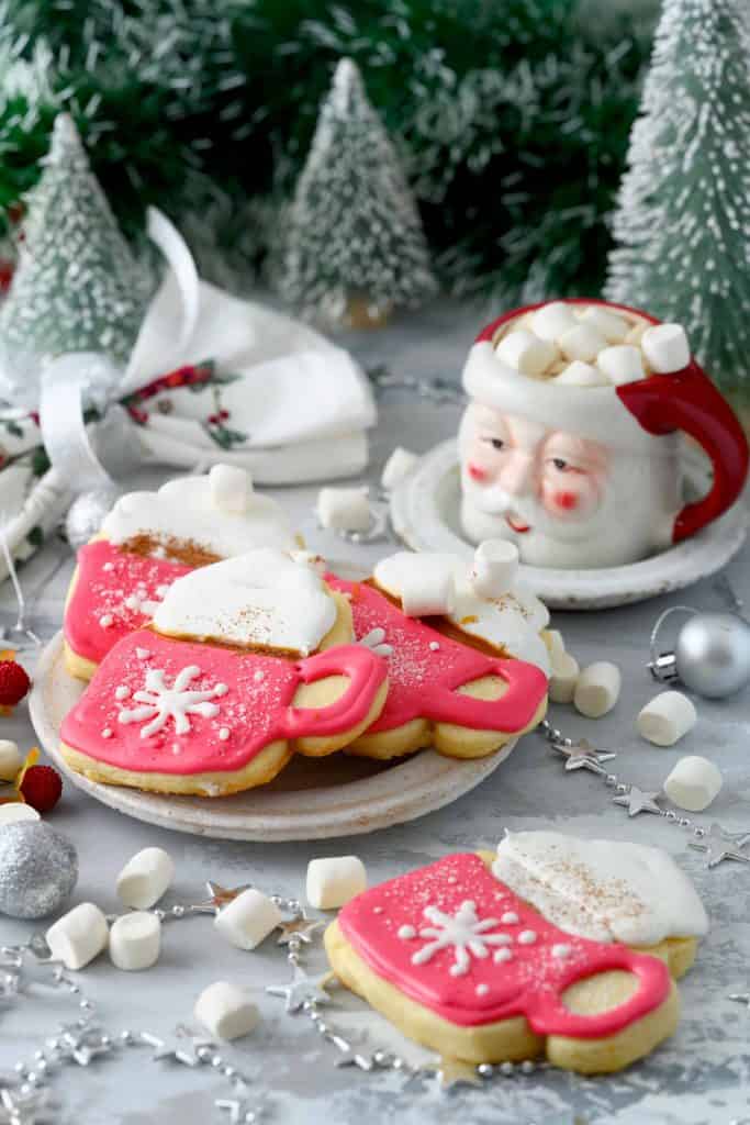 Cocoa mug sugar cookies next to Santa Claus mug