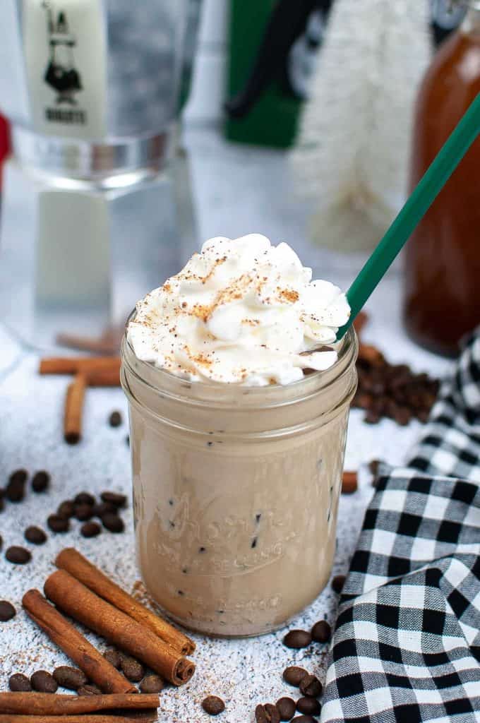 Gingerbread latte with a straw in it.
