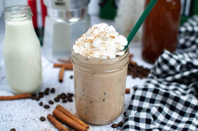 Head on view of coffee drink with whipped cream.