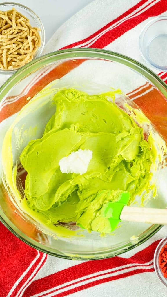 Melted bright green candy melts with coconut oil on top.