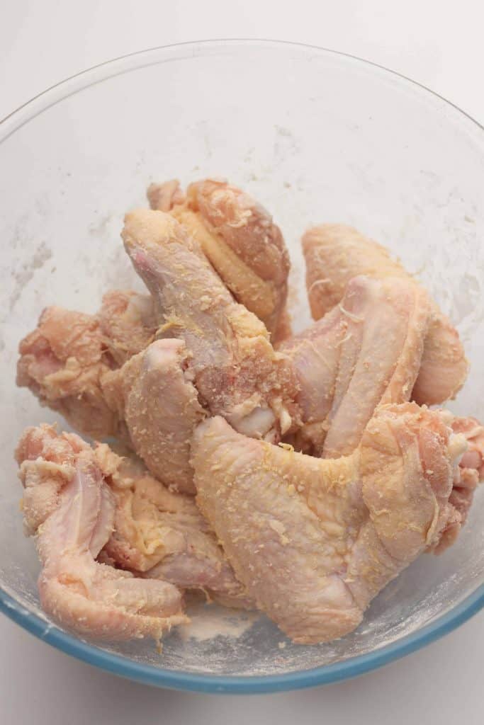 Chicken wings coated in flour.