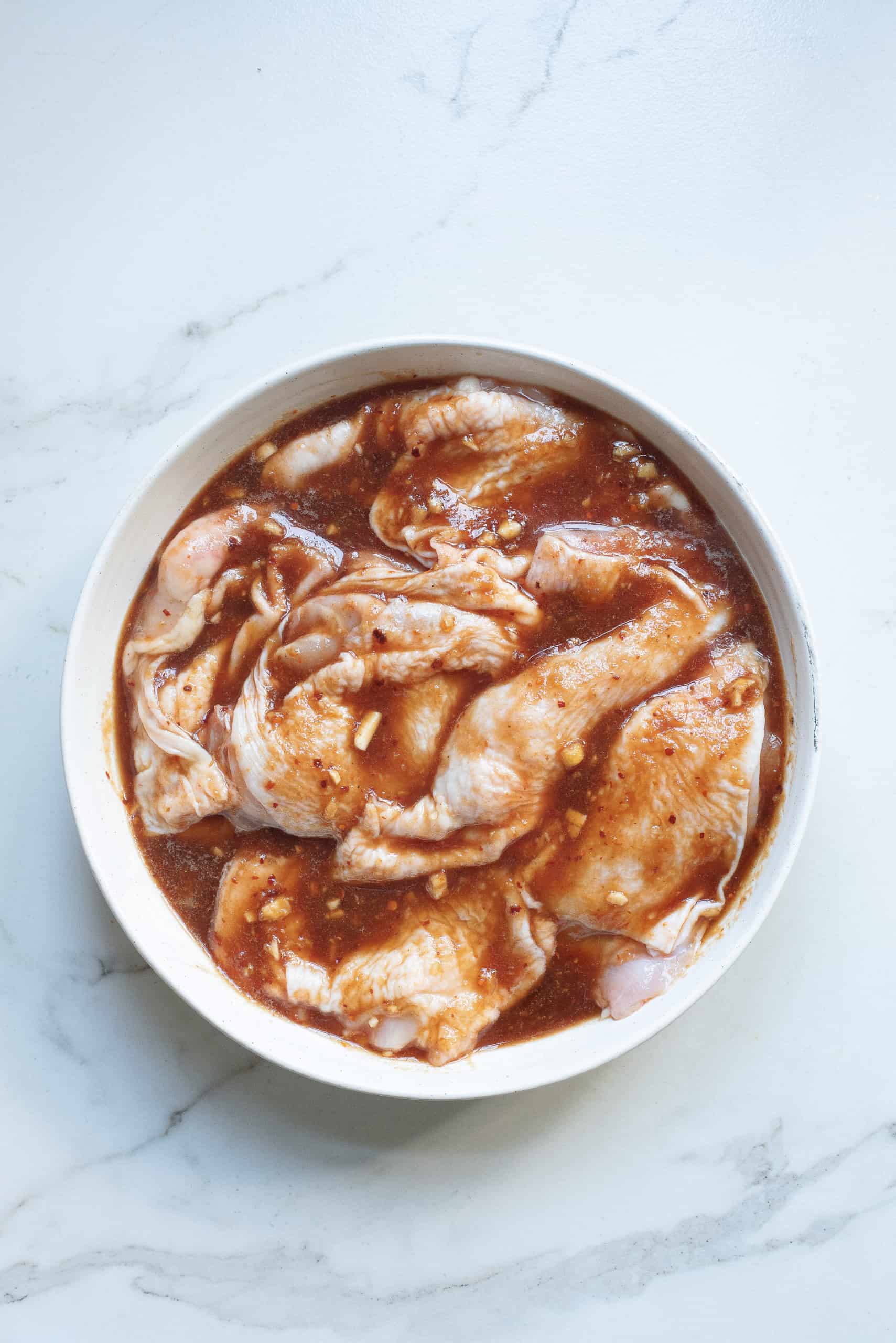 Overhead view of chicken in Hawaiian marinade.