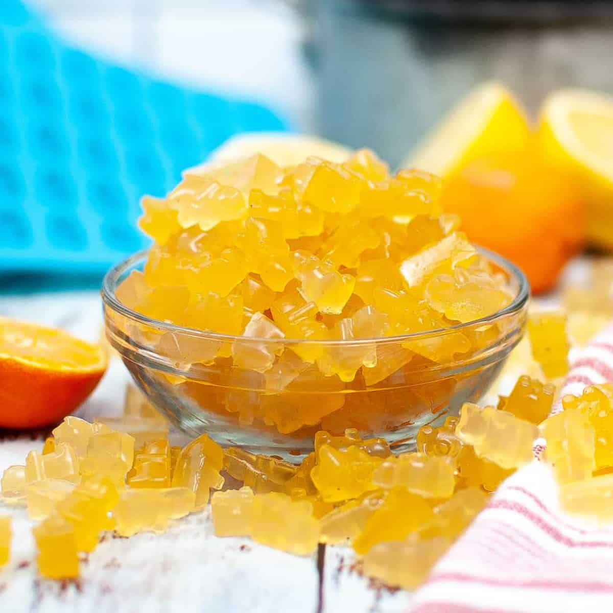 Citrus gummy bears in a glass bowl.