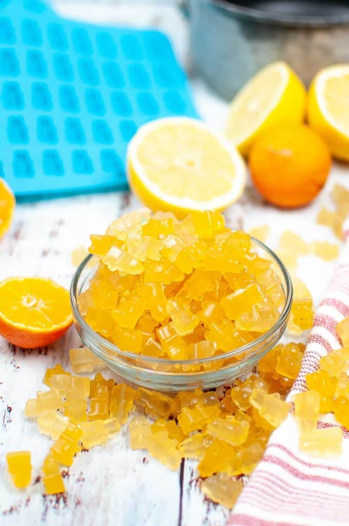 Citrus gummy bears in a glass bowl.