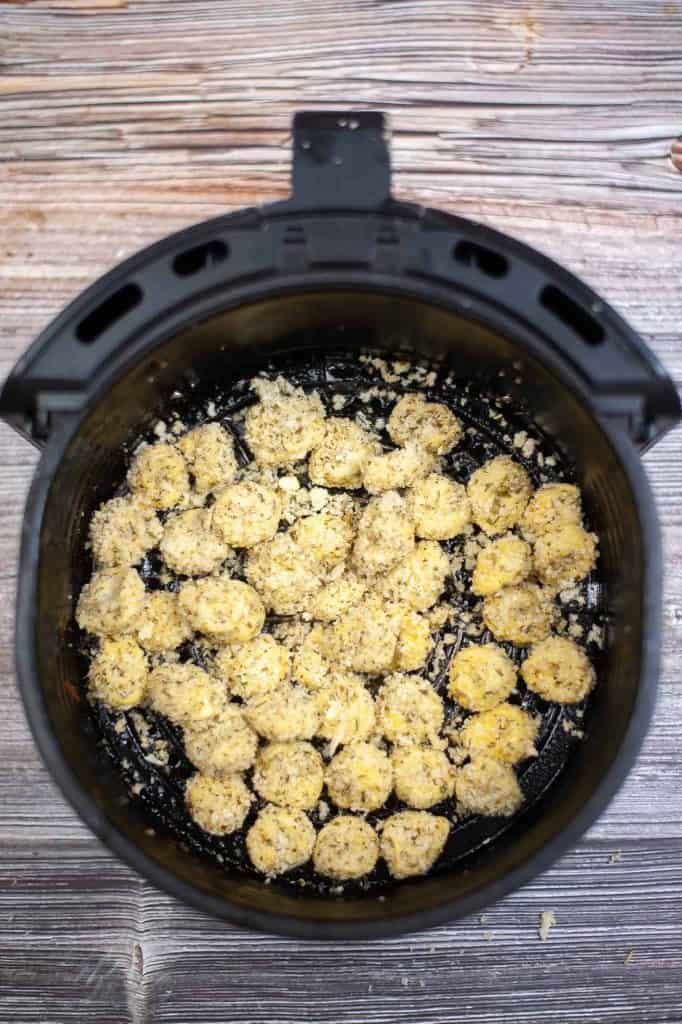 Overhead view of tortellini in an air fryer basket.