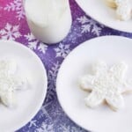 Snowflake cookies on white plates.