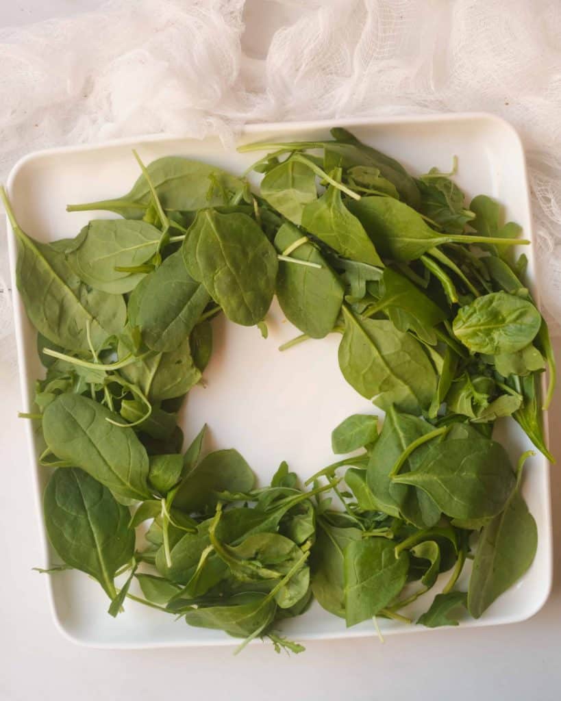 Spinach wreath on a white plate.