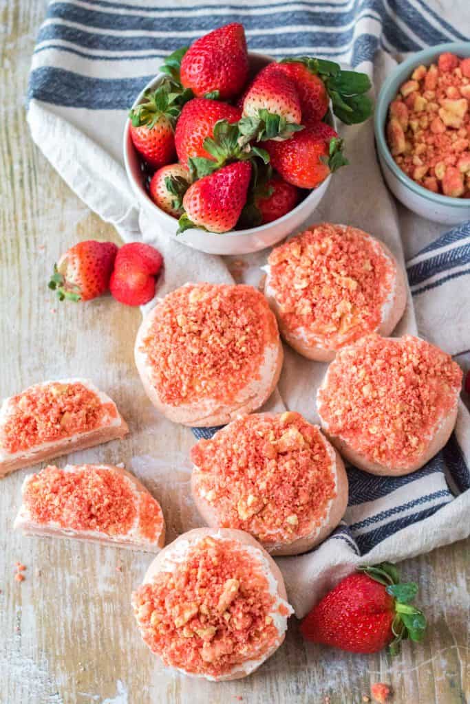 Overhead view of frosted strawberry cookies with crunch topping.