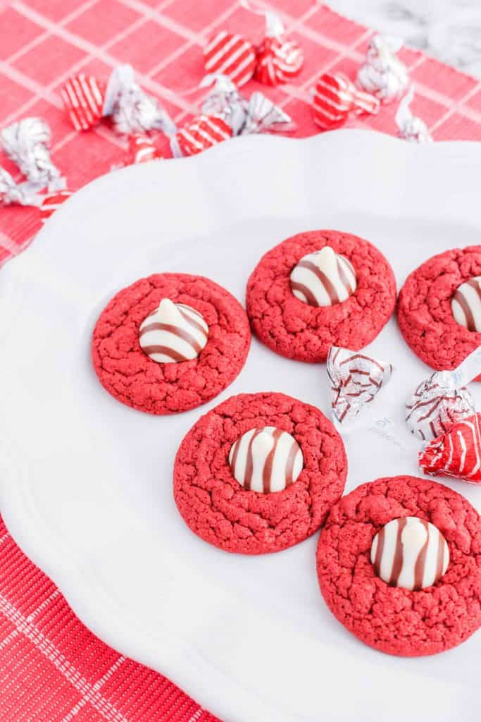Red velvet blossom cookies on a white platter.