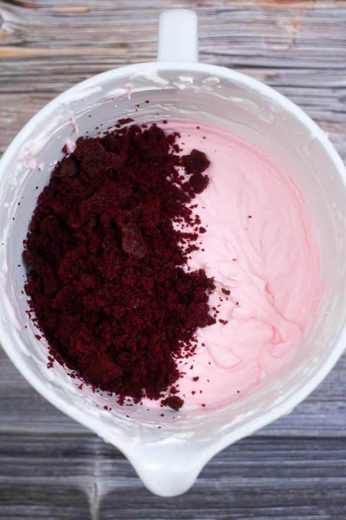 Red velvet crumbs in a bowl with pink ice cream.