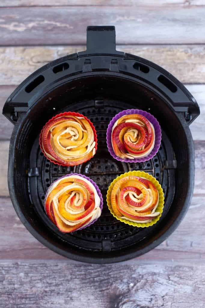 Apple roses in silicone liners in the air fryer.