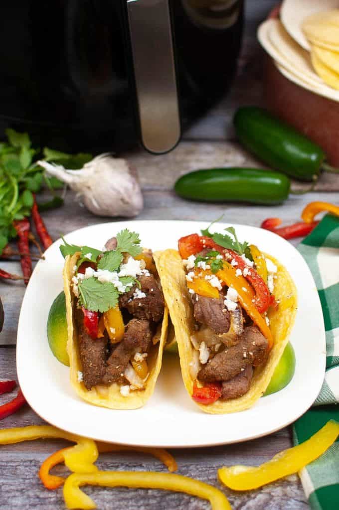Beef fajitas in front of the air fryer.
