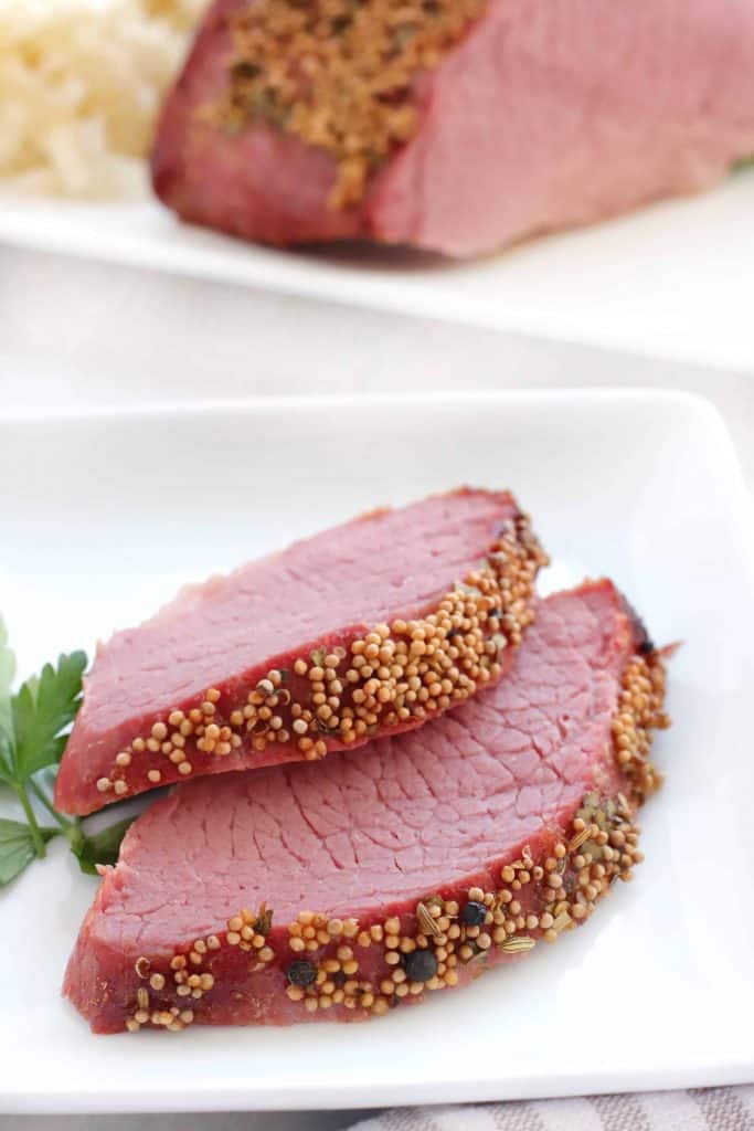 Closeup of two slices of corned beef.