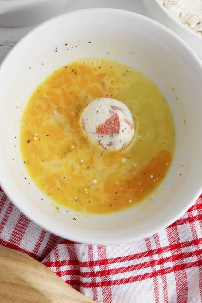 Pizza bomb coated in egg dip.