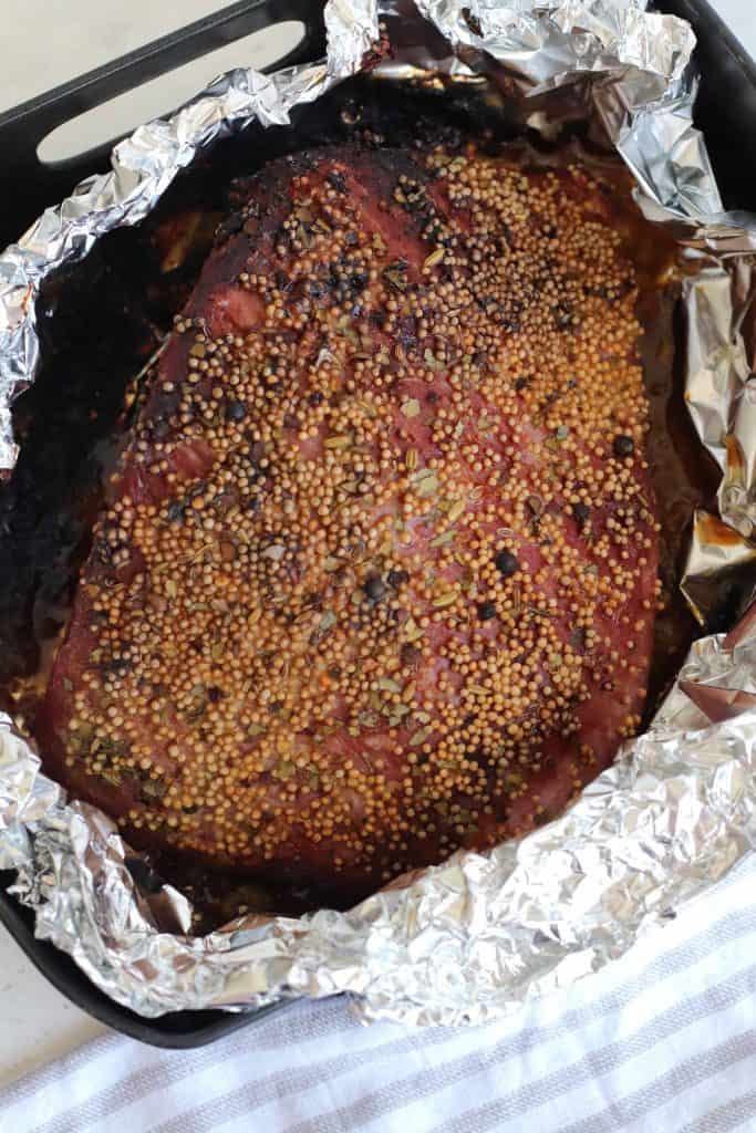 Cooked corned beef in foil lined air fryer basket.