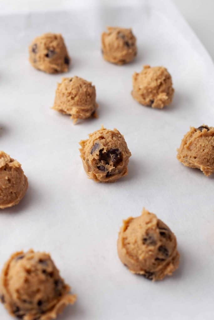 Cookie dough balls on a baking sheet.