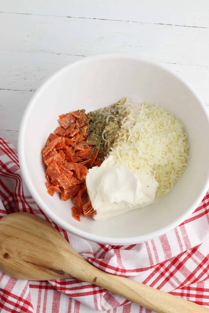 Pizza bomb filling in a white bowl.