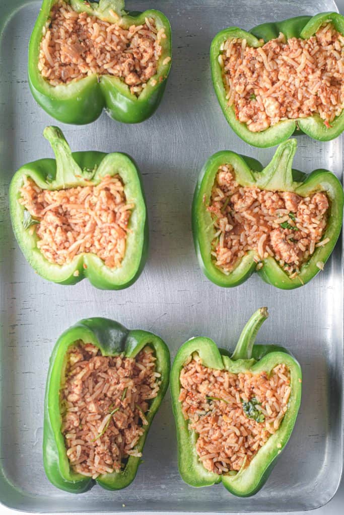 Green bell peppers stuffed with chicken and rice.