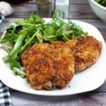 Honey glazed chicken on a white plate.