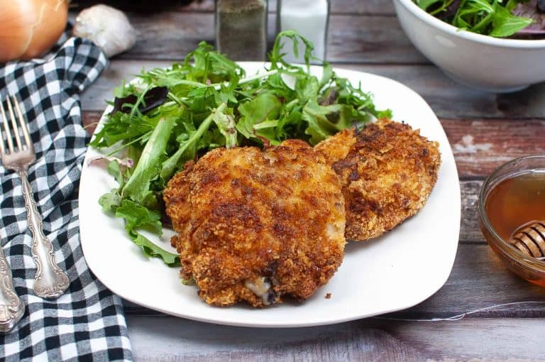 Honey glazed chicken on a white plate.
