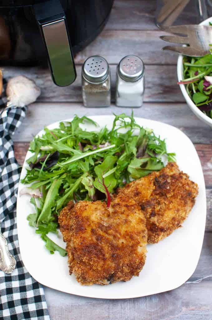 Overhead view of air fryer chicken thighs with honey glaze.