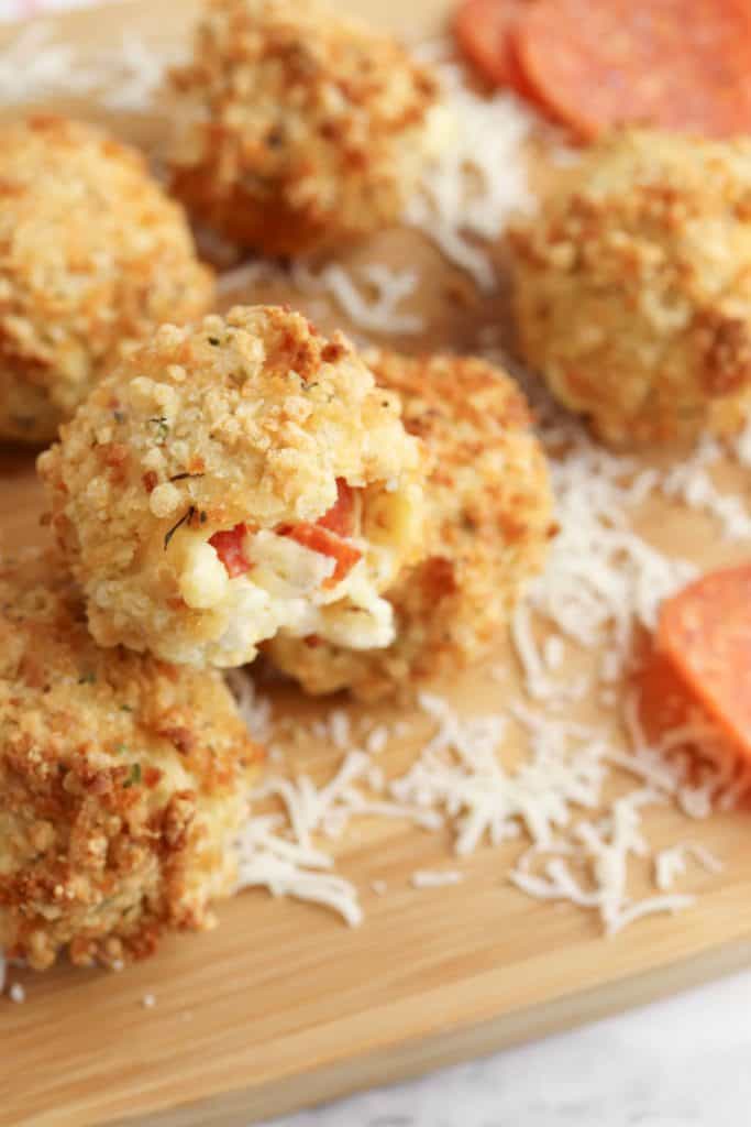 Pizza bites with pepperoni on a cutting board.