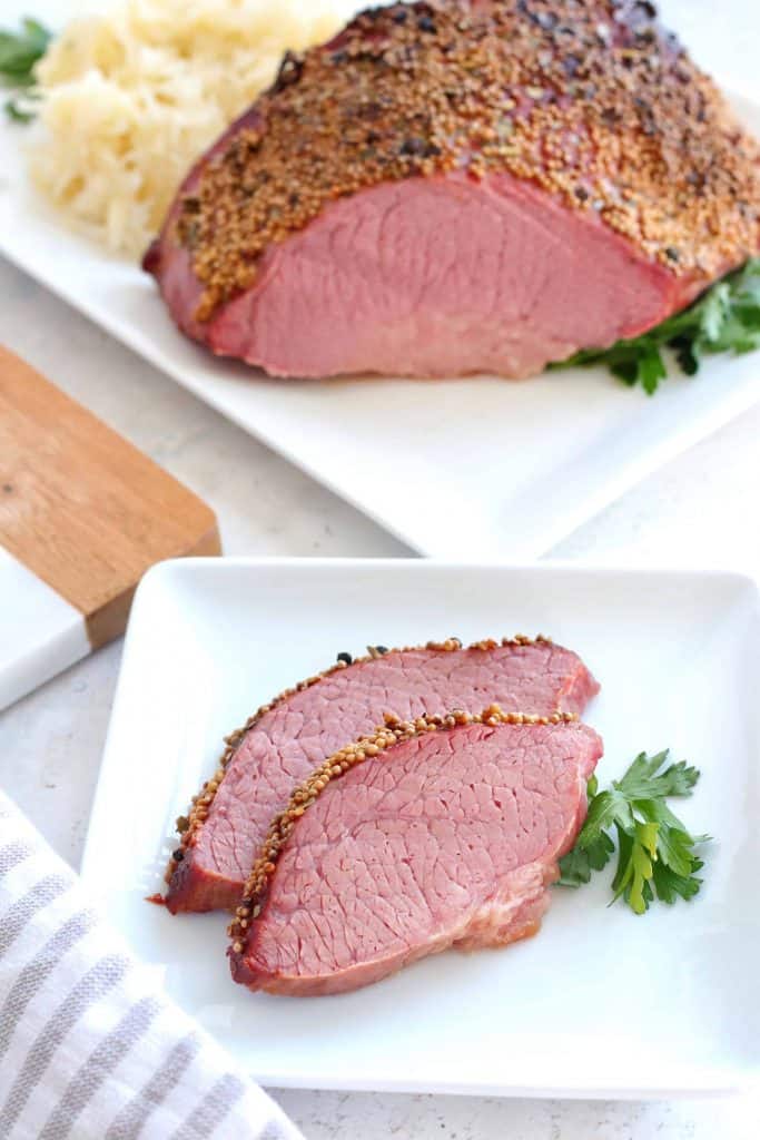 Sliced corned beef on a white plate.