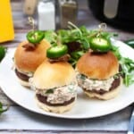 Jalapeno sliders on a white plate.