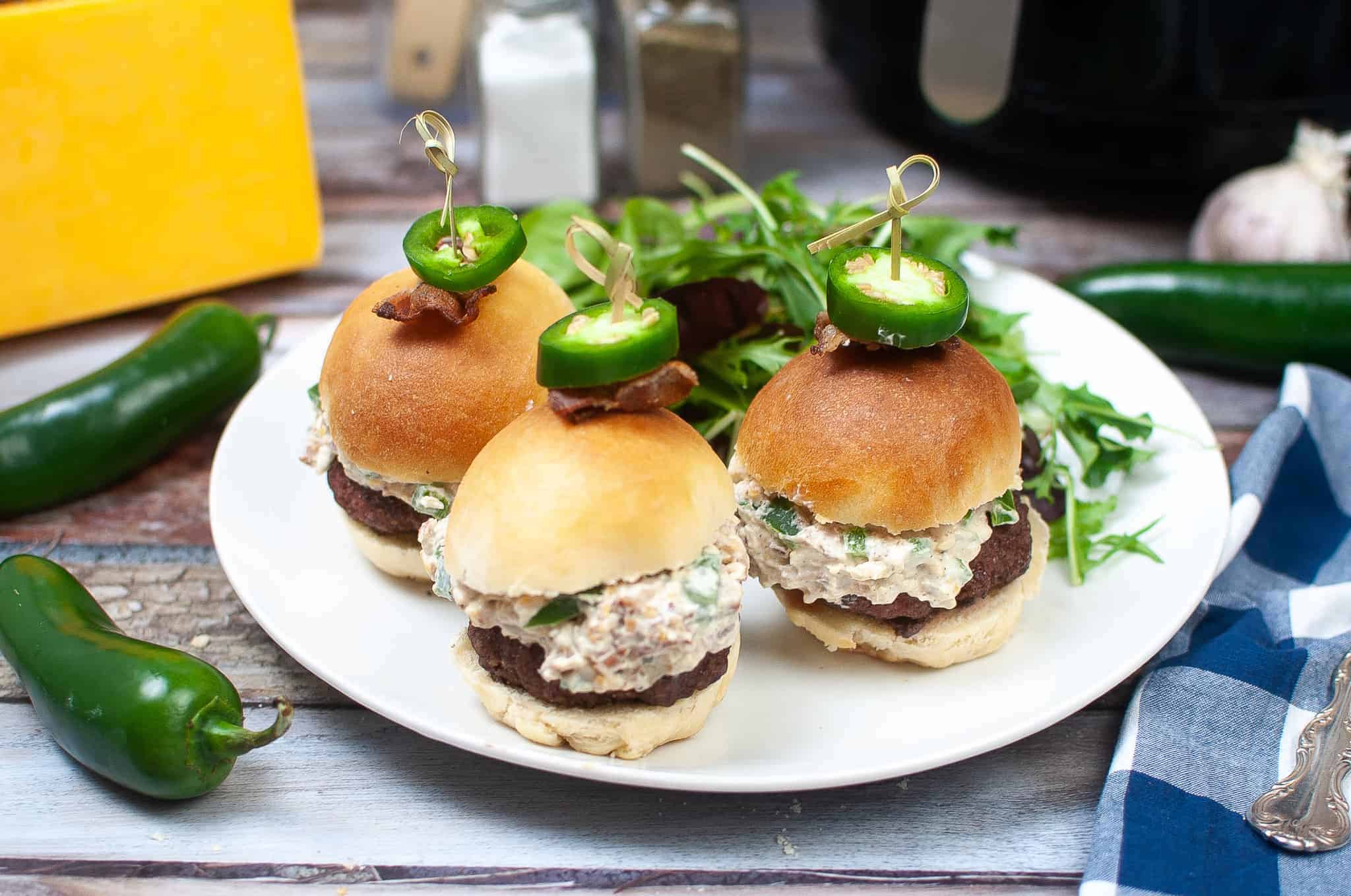 Jalapeno sliders on a white plate.