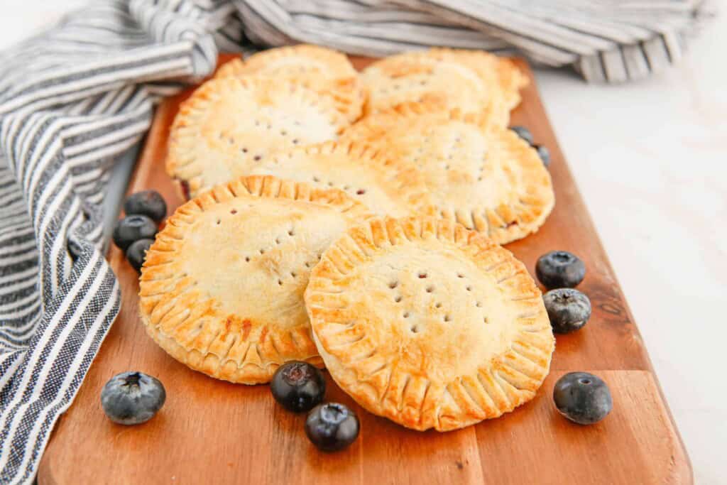 Air Fryer Blueberry Hand Pies on a Cutting Board.