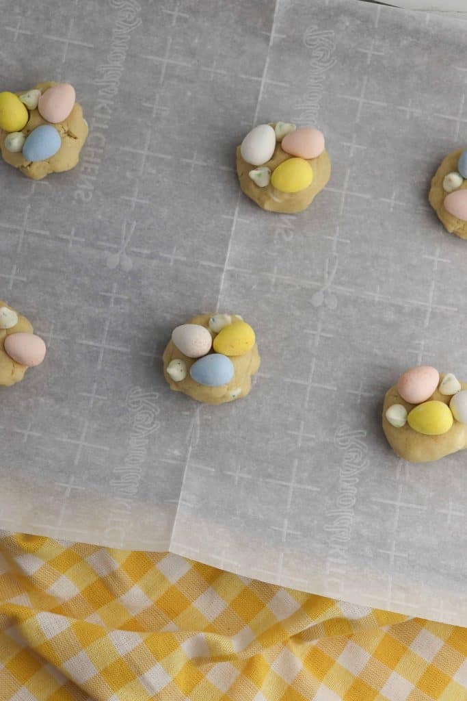 Cadbury mini eggs cookies on parchment paper.