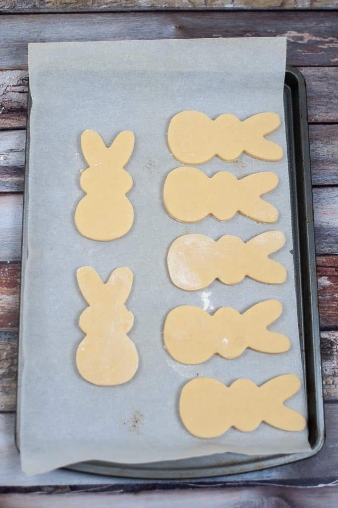 Cut out bunny cookies on parchment paper lined cookie sheet.