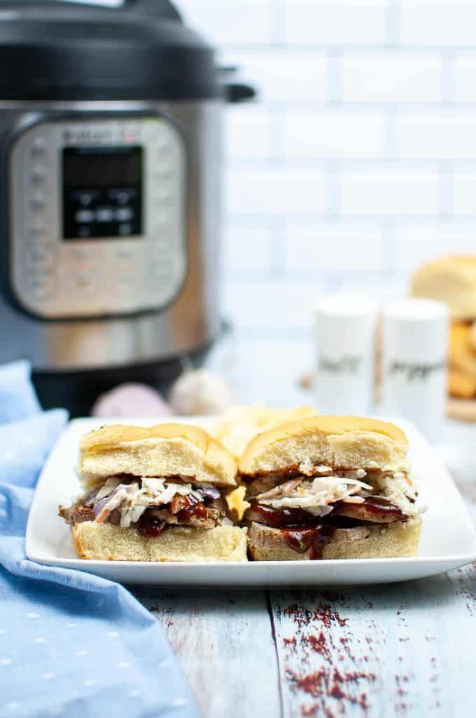 Head-on photo of pork sliders in front of an Instant Pot.