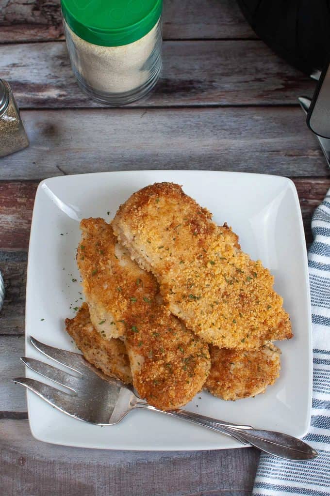 Overhead view of parmesan crusted chicken cooked in the air fryer.
