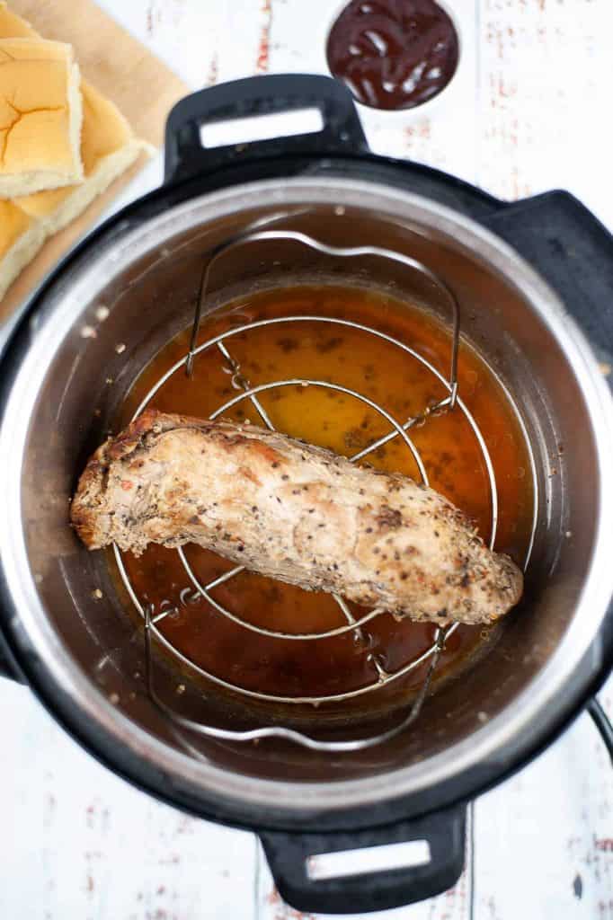 Pork tenderloin on a trivet in an Instant Pot.