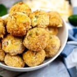Closeup of jalapeno popper bites in a white bowl.