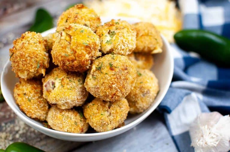 Closeup of jalapeno popper bites in a white bowl.
