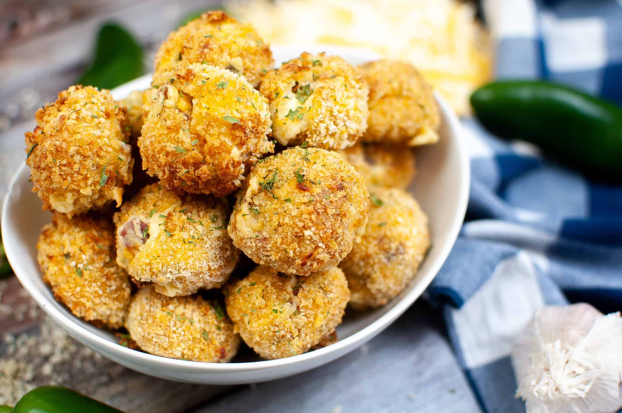Closeup of jalapeno popper bites in a white bowl.