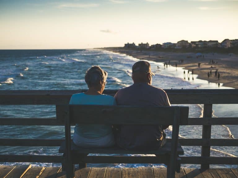 Elderly people sitting on a bench.